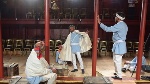 men in traditional dress on a boat