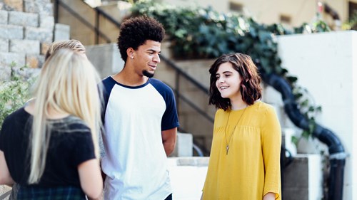 Young people in conversation in an outdoor setting