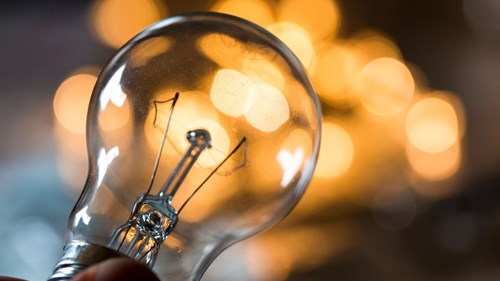 A bulb pictured in front of glowing lights